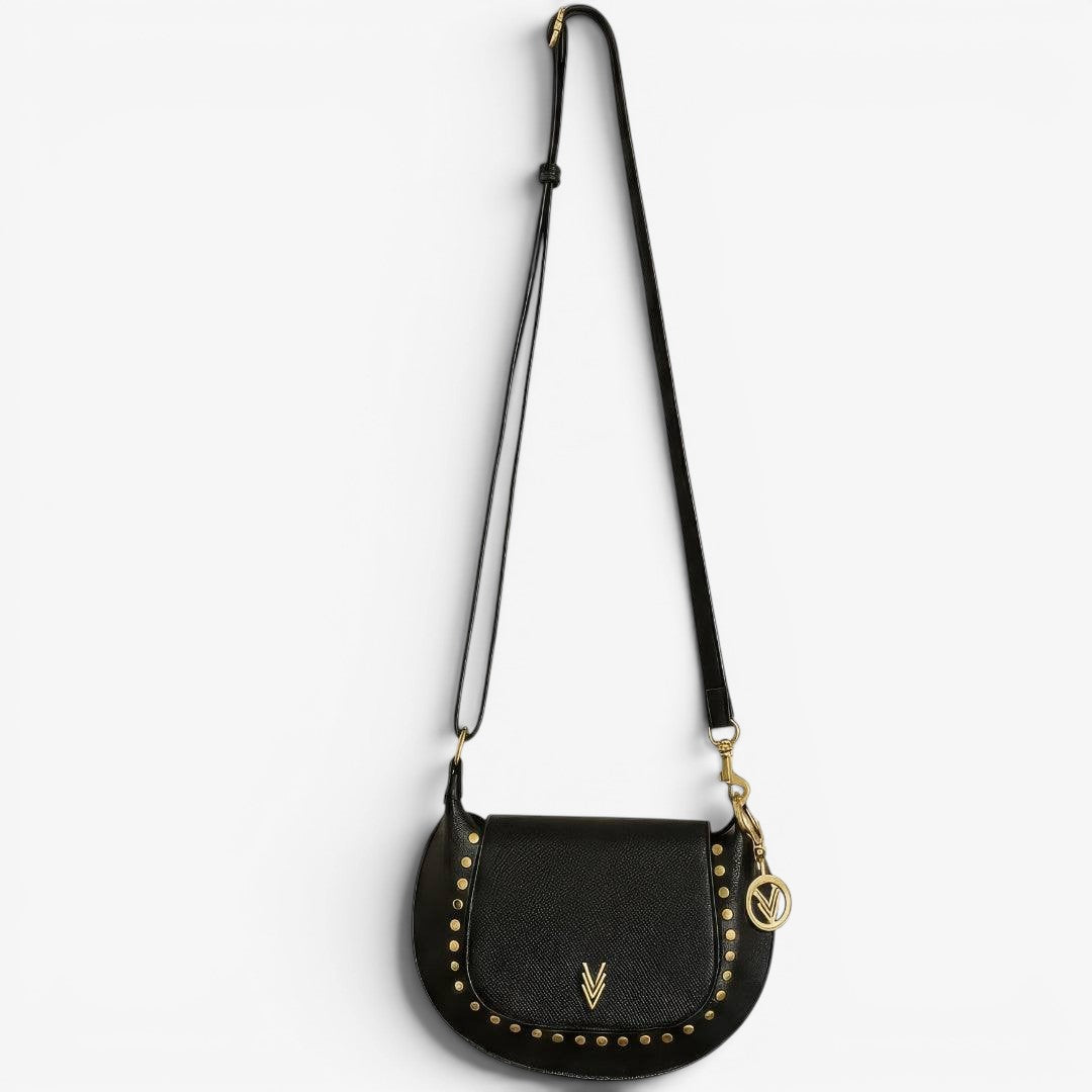 Black crossbody bag with gold accents on a white background