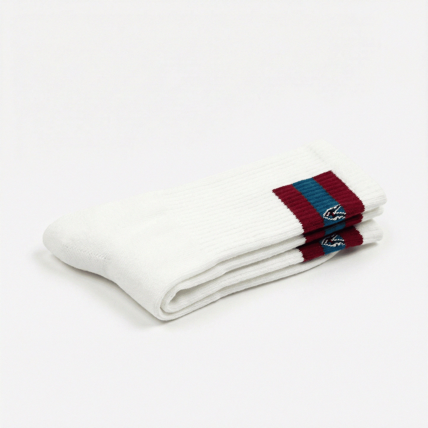 White socks with red and blue striped cuffs on a white background