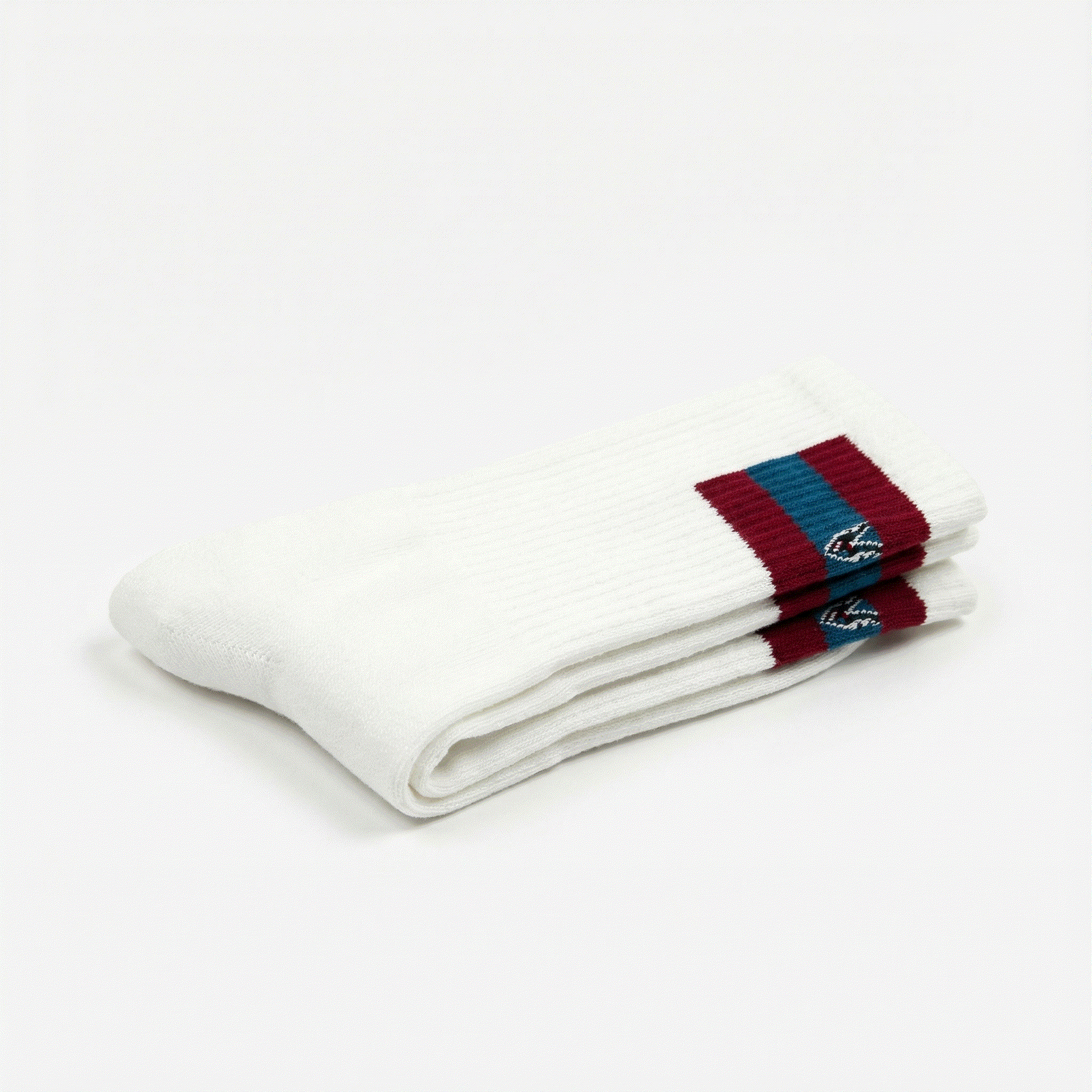 White socks with red and blue striped cuffs on a white background