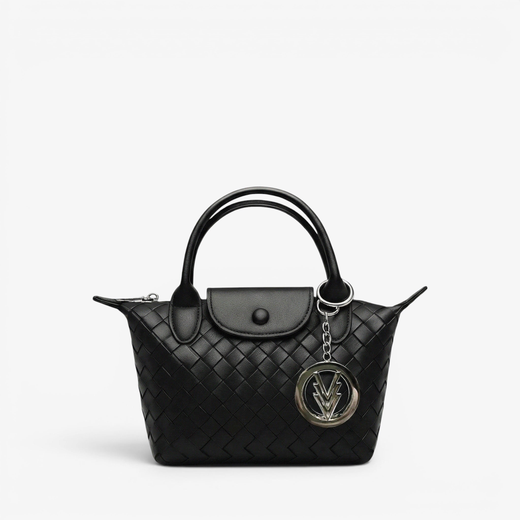 Black quilted handbag with a chain detail on a light gray background