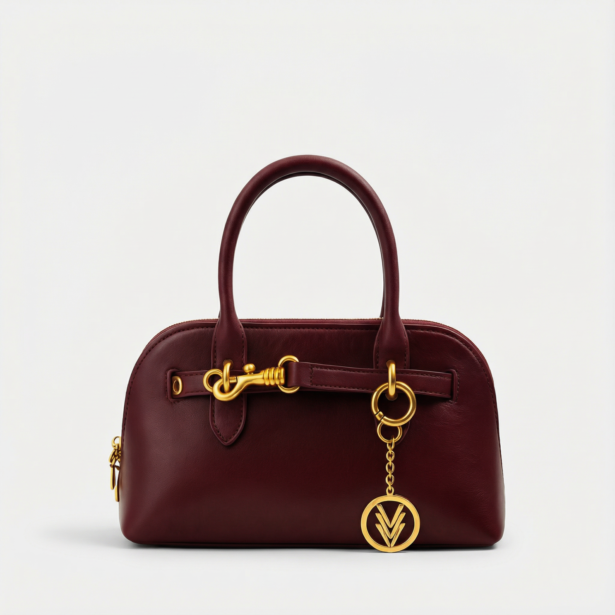 Burgundy handbag with gold accents on a light gray background