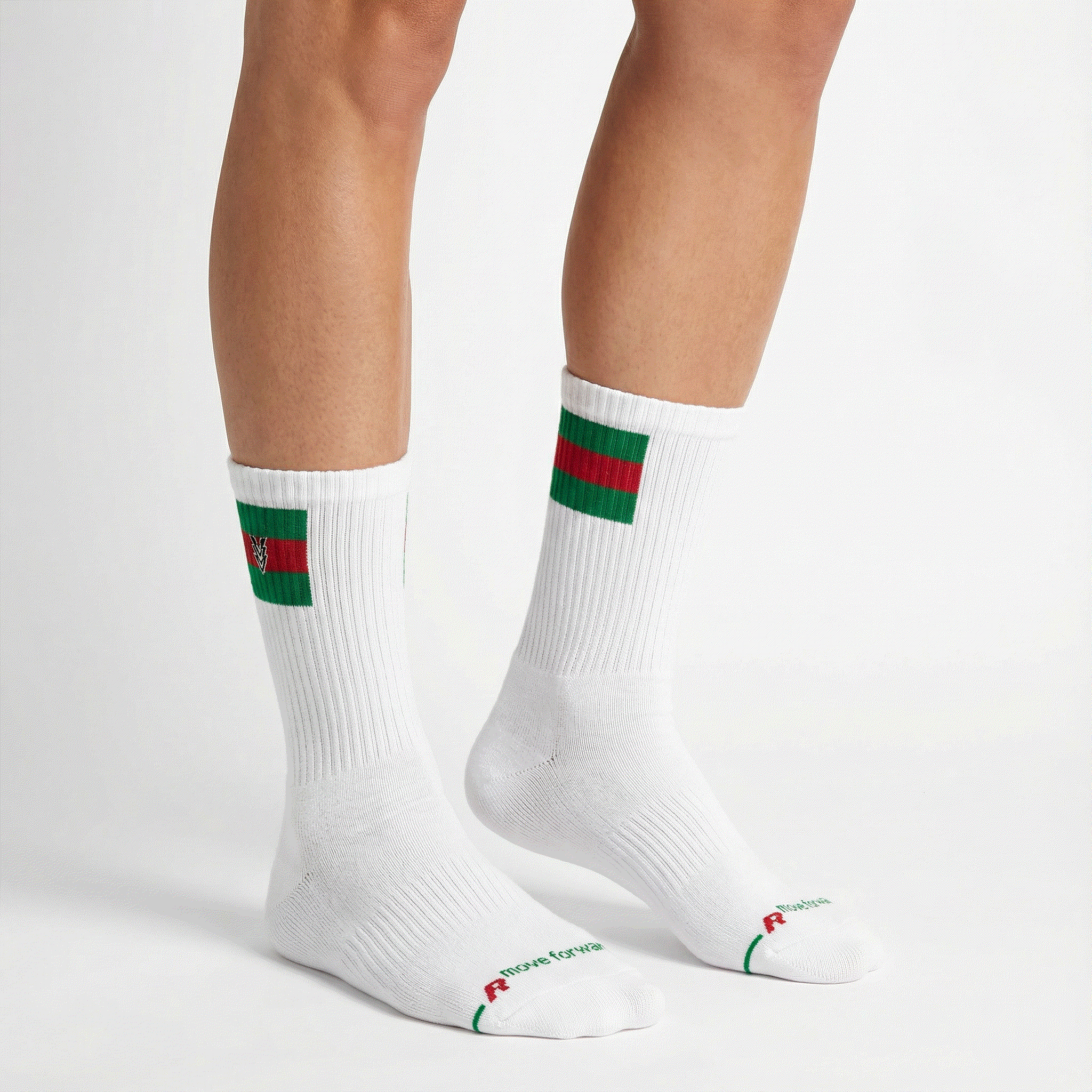 White socks with green and red stripes worn by a person on a white background