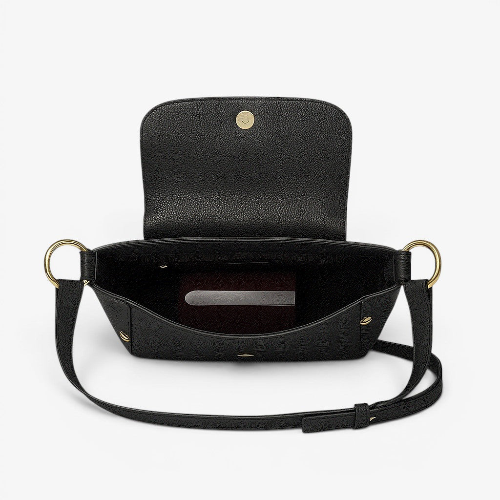Black handbag with gold accents on a light gray background
