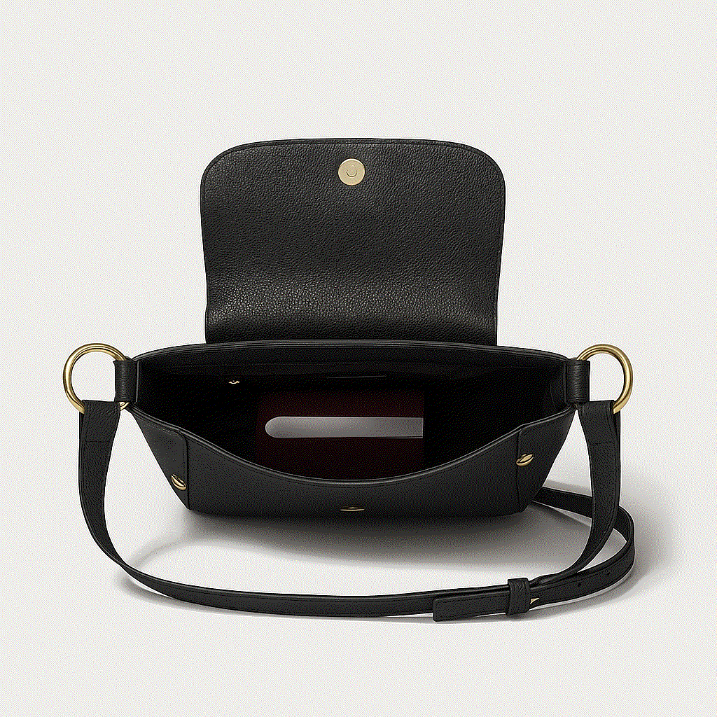 Black handbag with gold accents on a light gray background