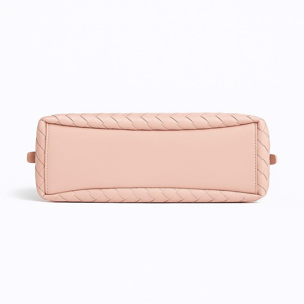 Pink quilted handbag on a white background