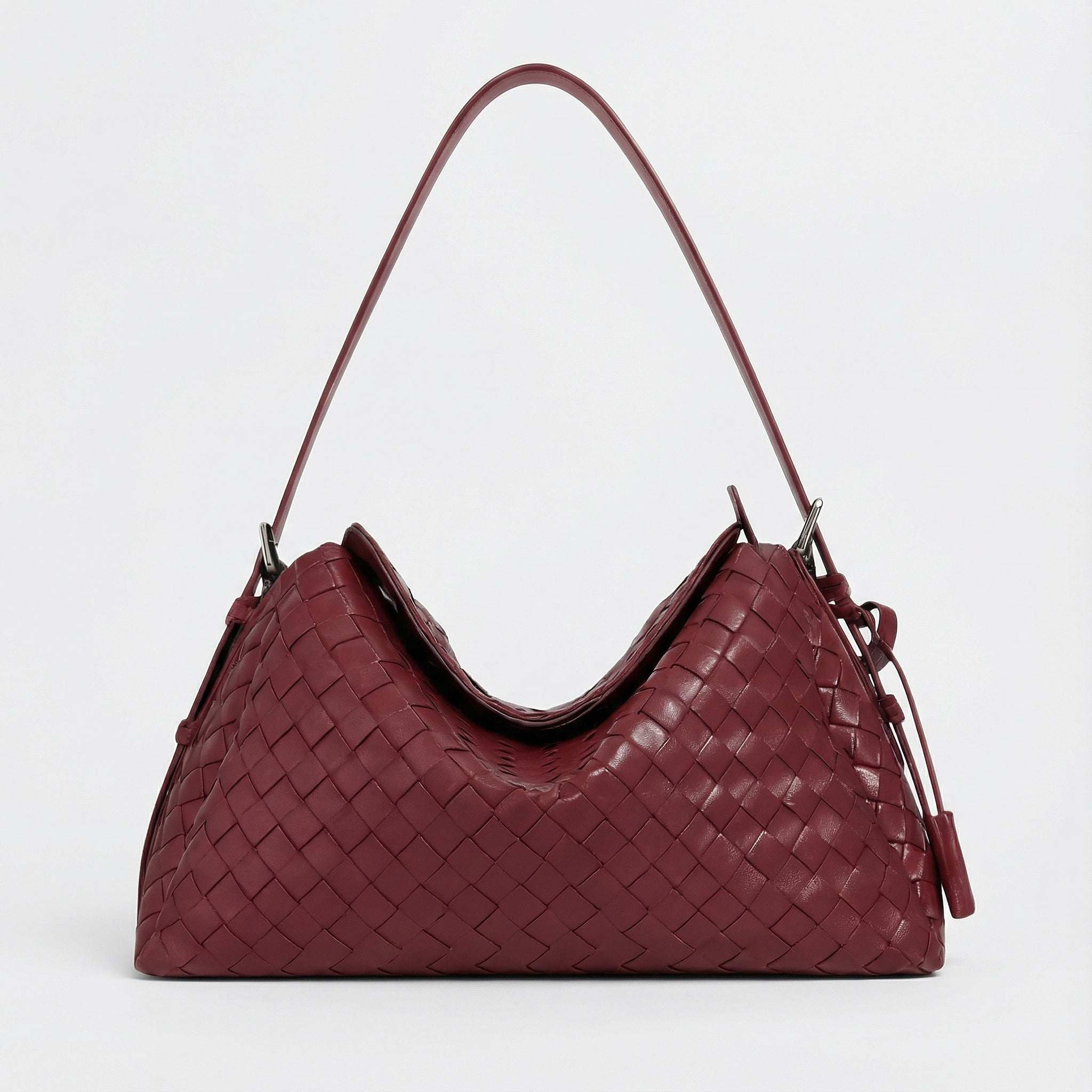 Maroon woven handbag on a light gray background
