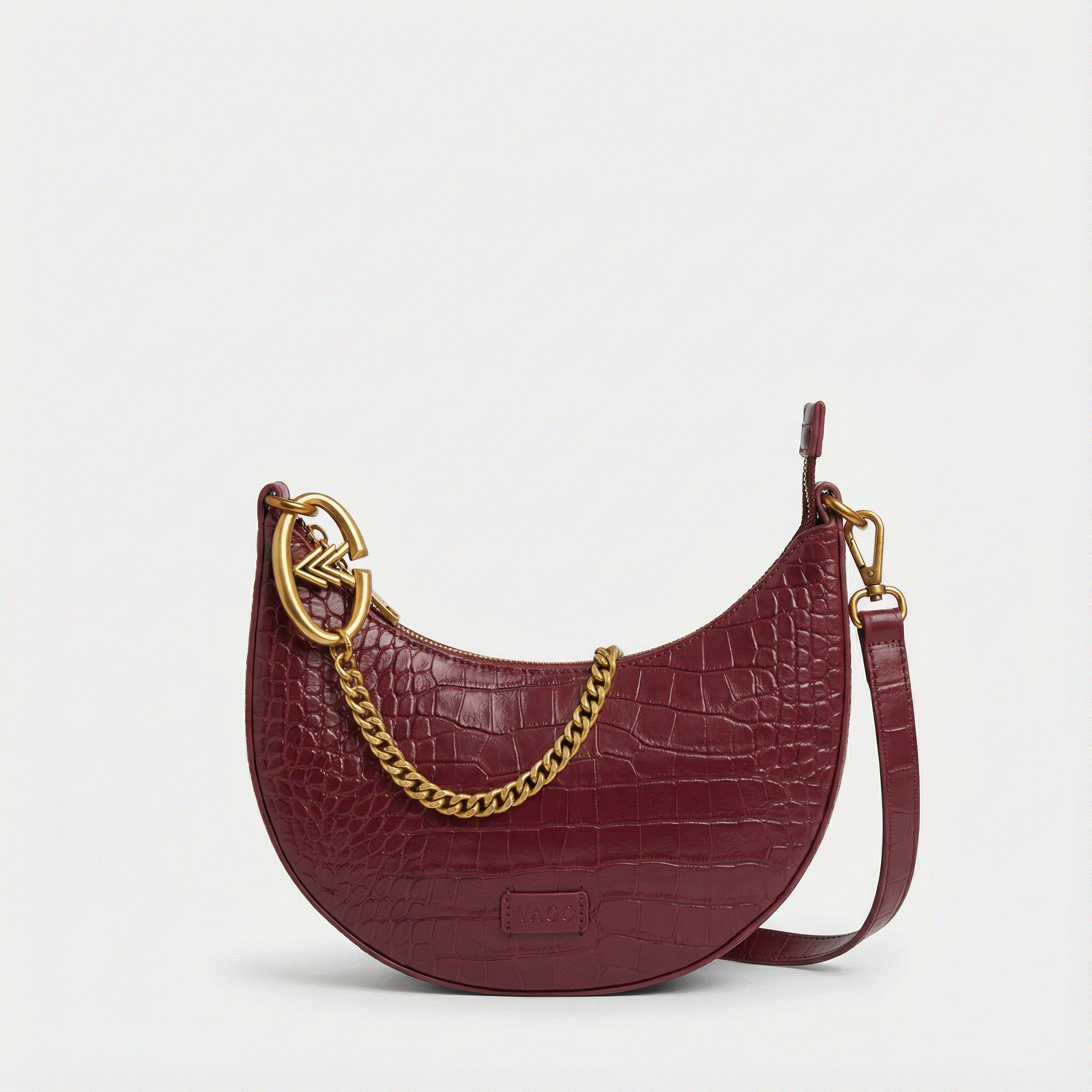Maroon handbag with gold chain detail on a light gray background