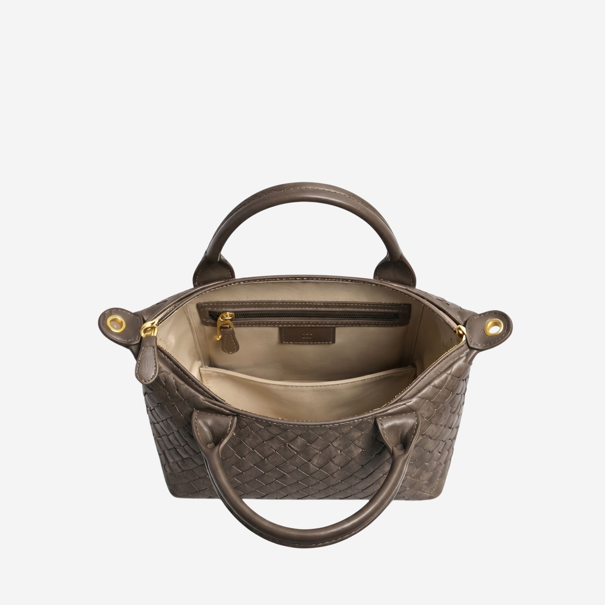 Brown woven handbag with gold accents on a white background