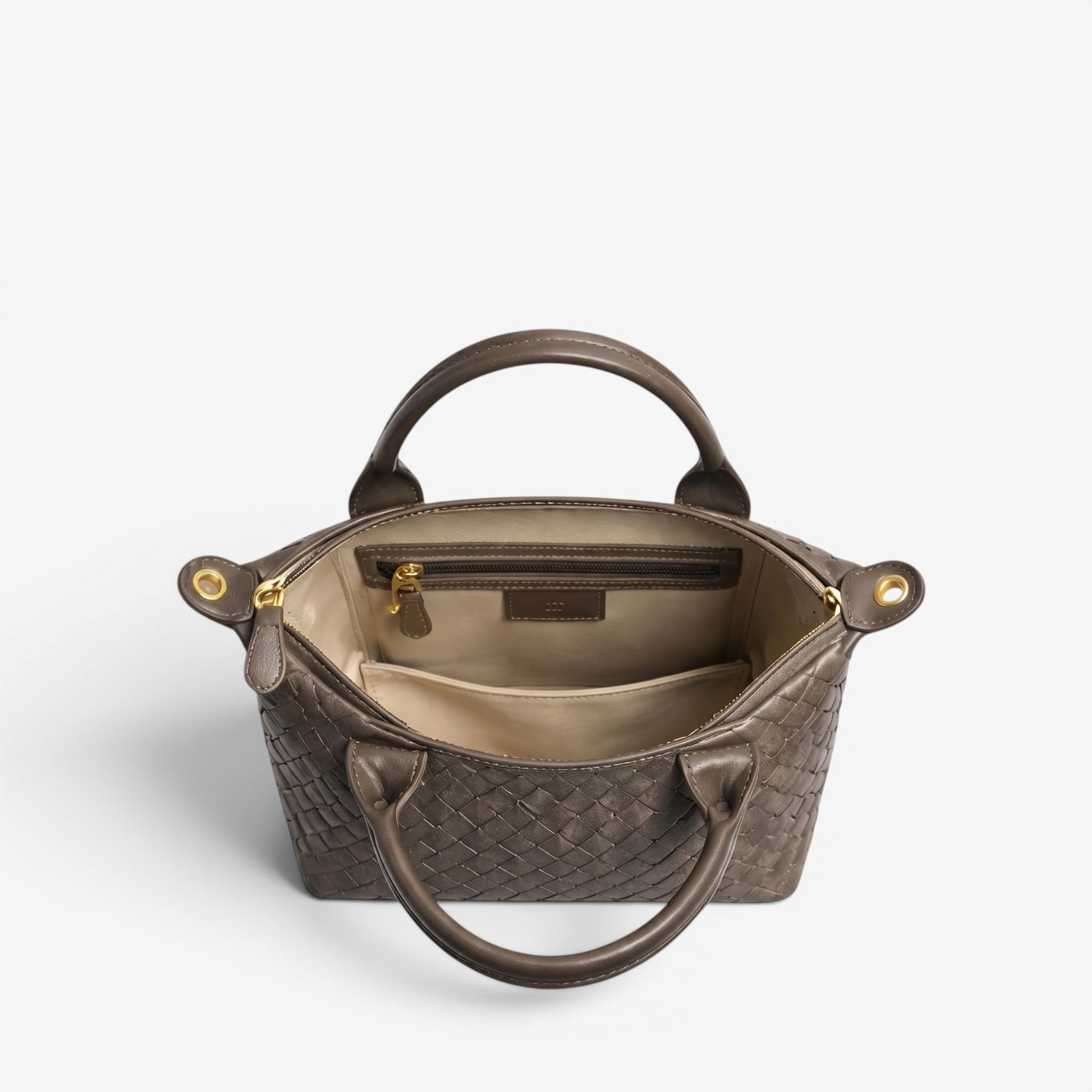 Brown woven handbag with gold accents on a white background