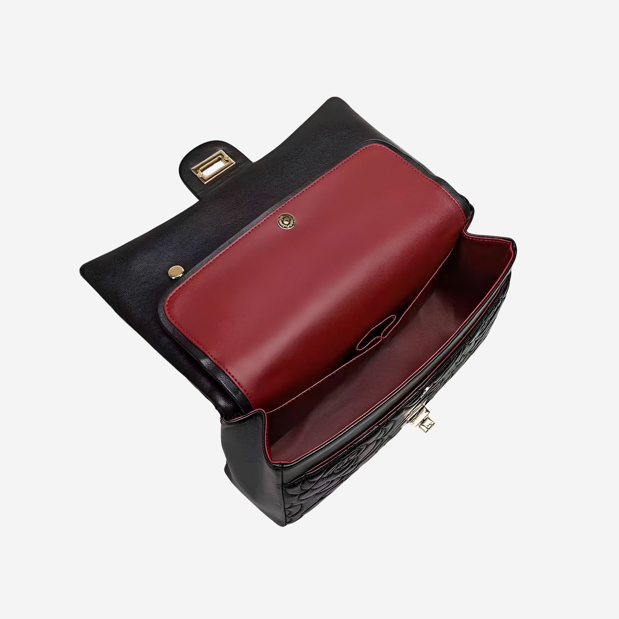 Black leather handbag with a red interior on a white background