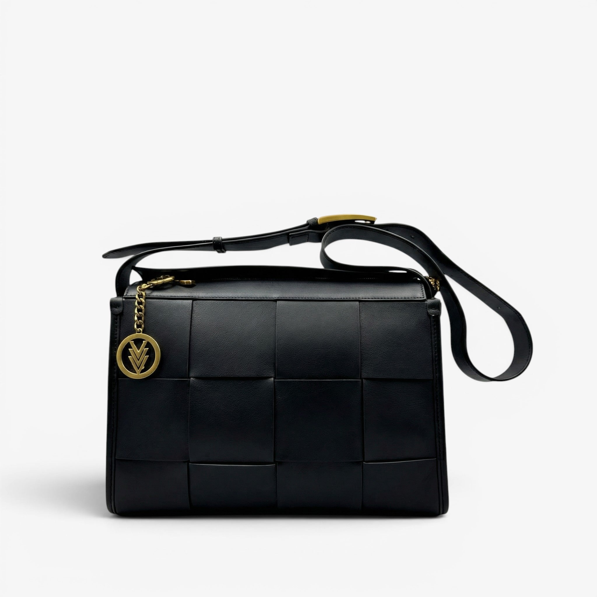Black woven handbag with gold accents on a light gray background
