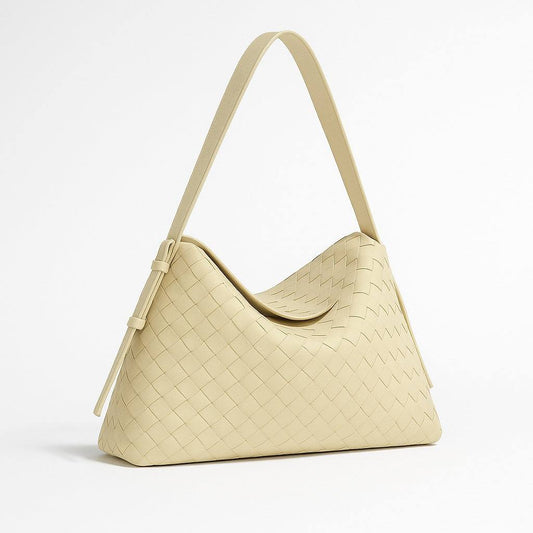 Beige woven handbag on a light gray background