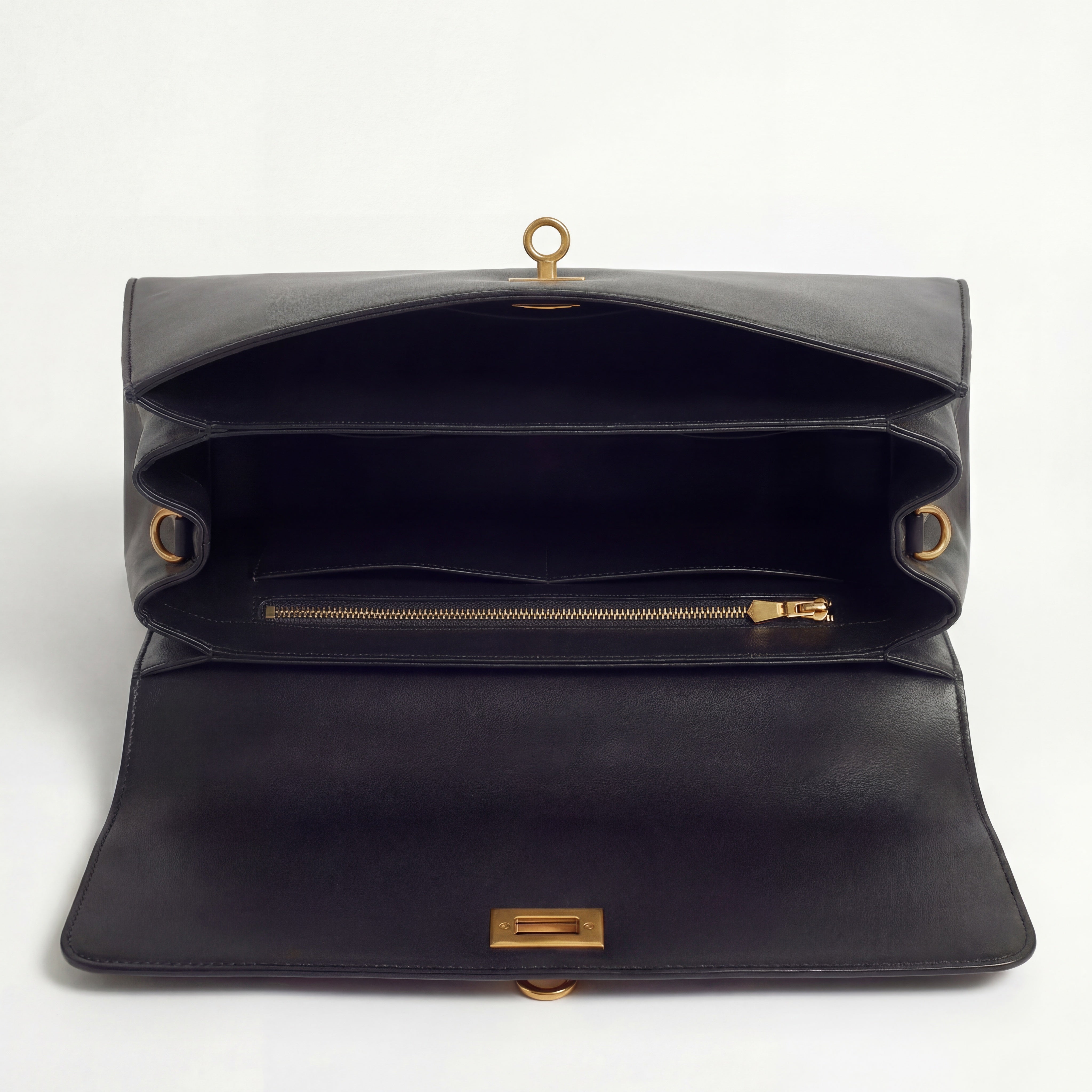 Black leather bag with gold hardware on a white background