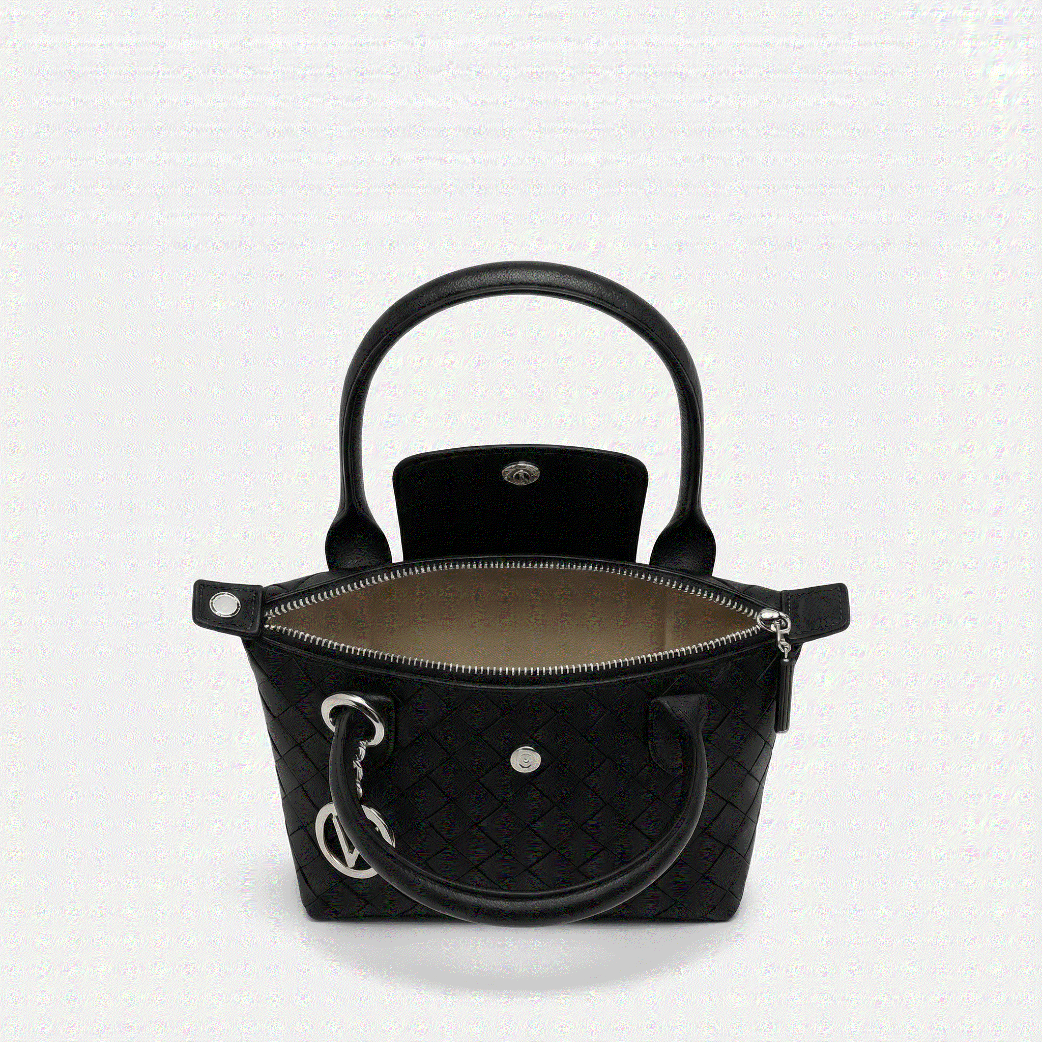 Black quilted handbag with gold hardware on a light gray background