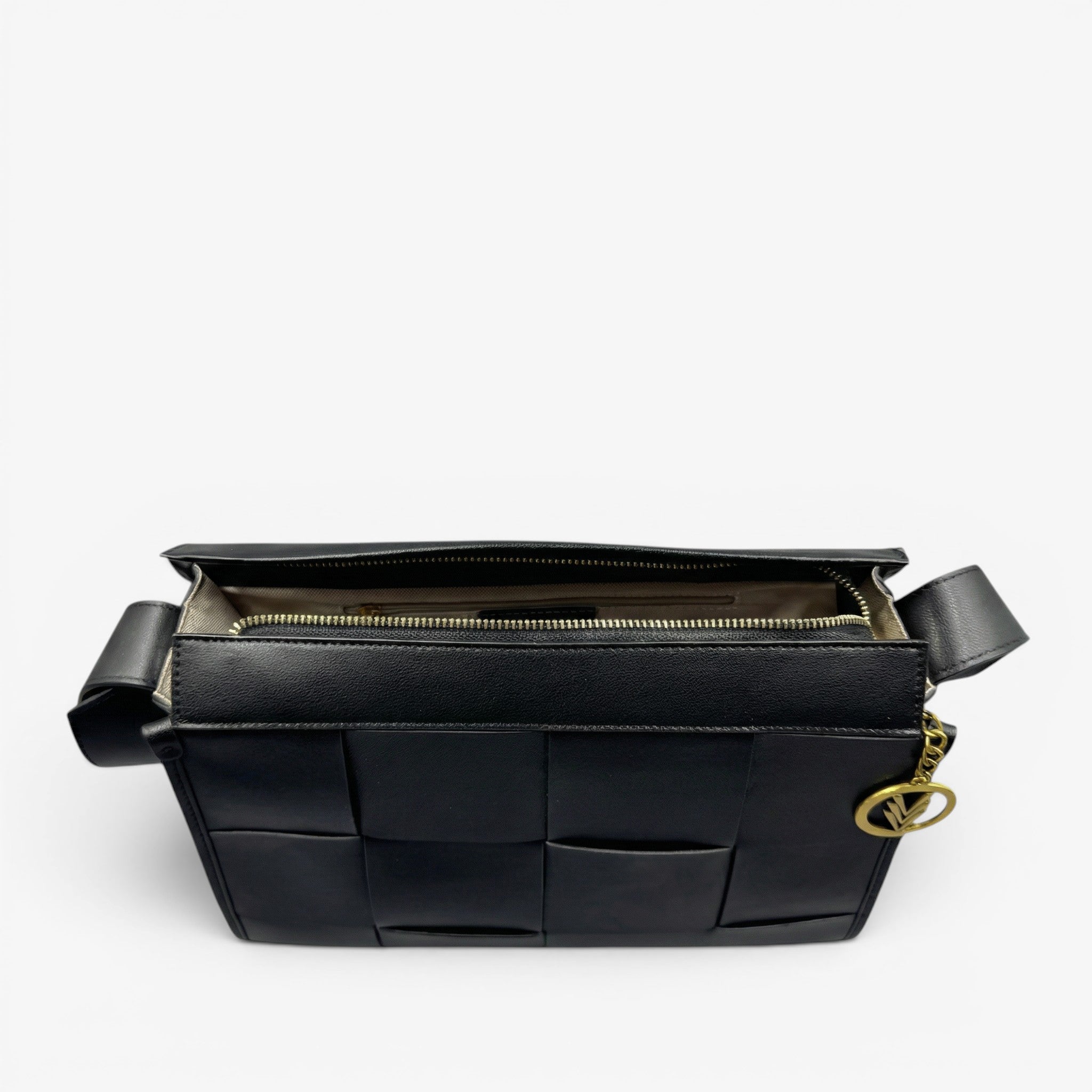 Black woven handbag with gold chain on a light gray background