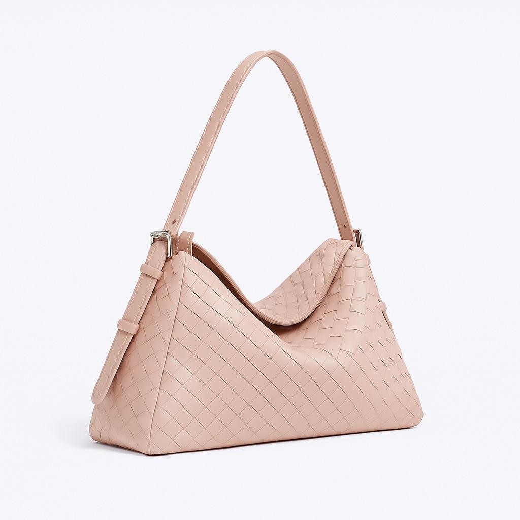 Pink handbag with a textured pattern on a light gray background