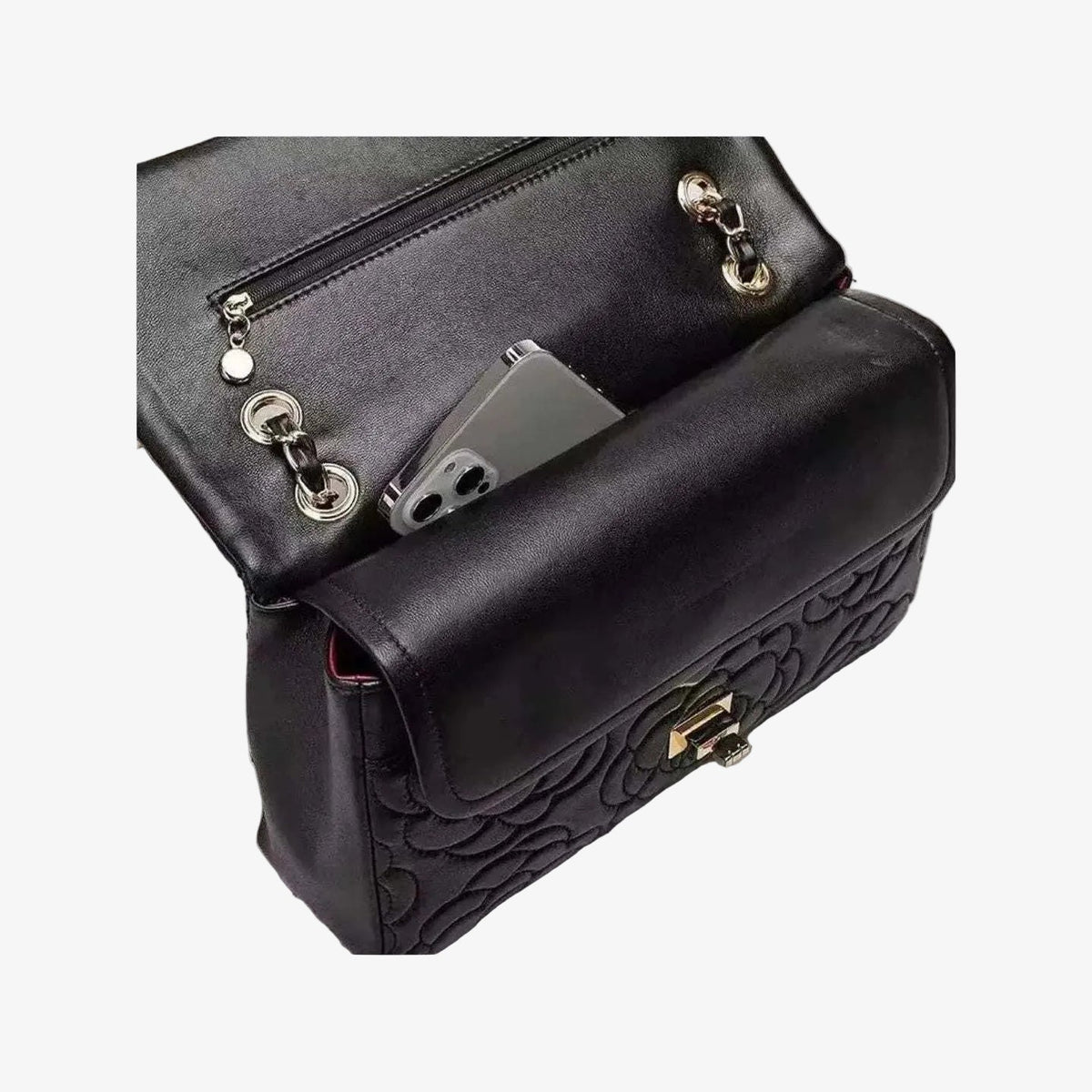 VAGOSHOPS Chiara quilted black leather bag with silver chain strap and interior pocket holding a smartphone