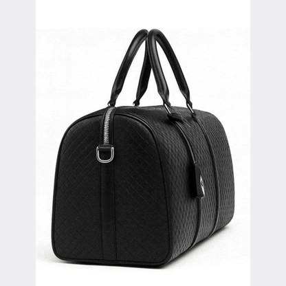 Black quilted duffel bag on a white background