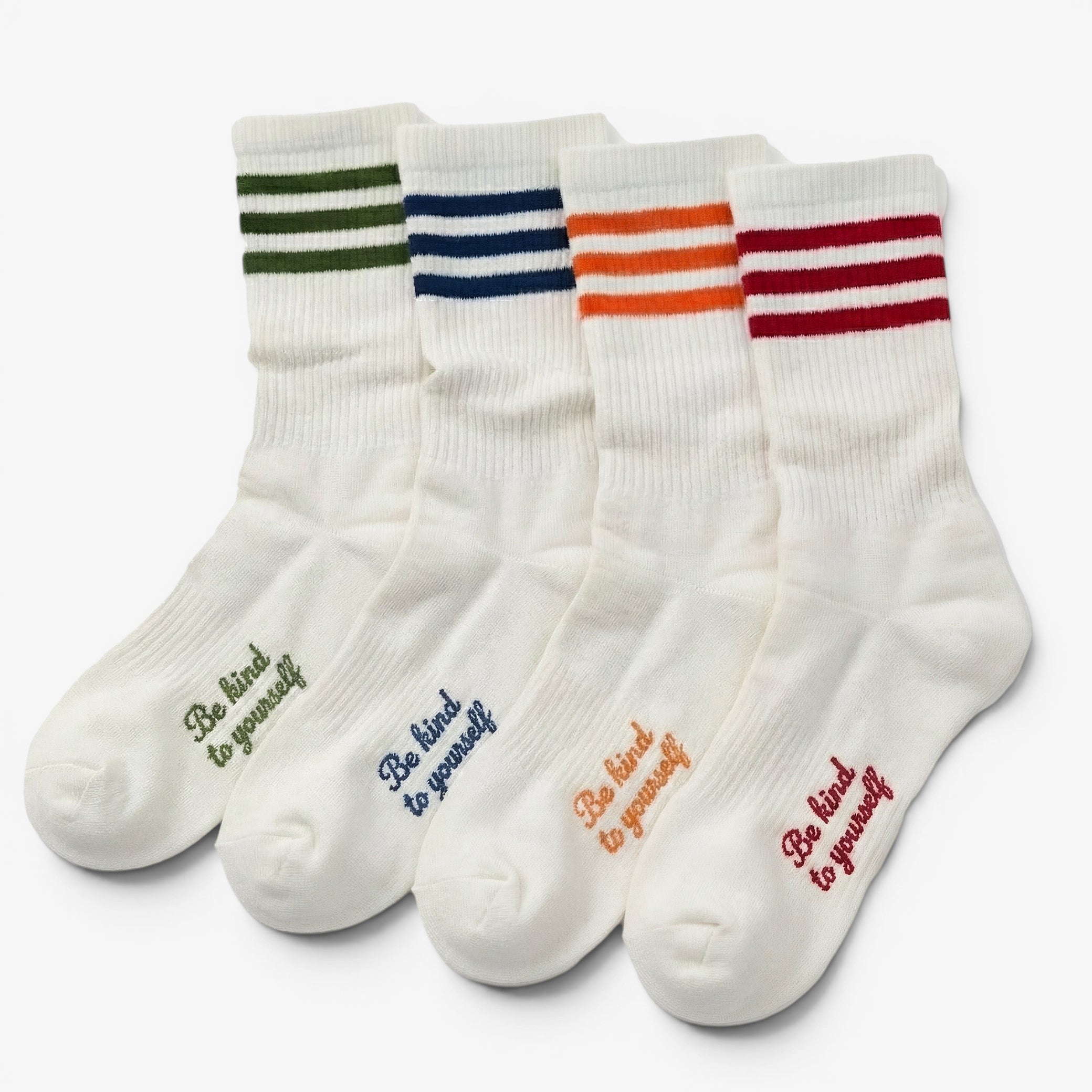 Set of five white socks with colorful stripes and motivational text on a white background