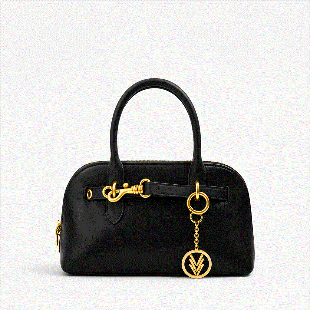 Black handbag with gold accents on a light gray background