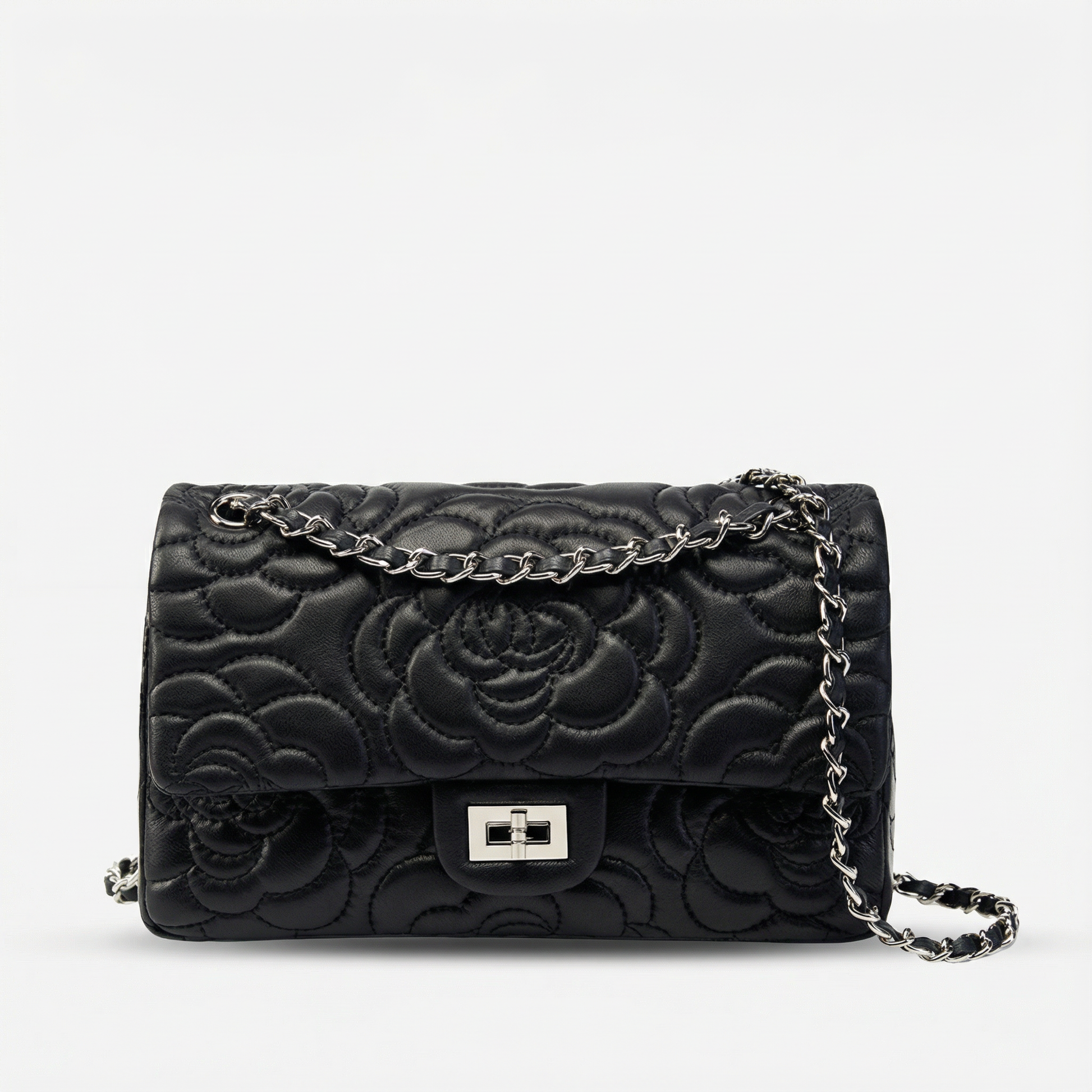 Black floral embossed handbag with a chain strap on a white background