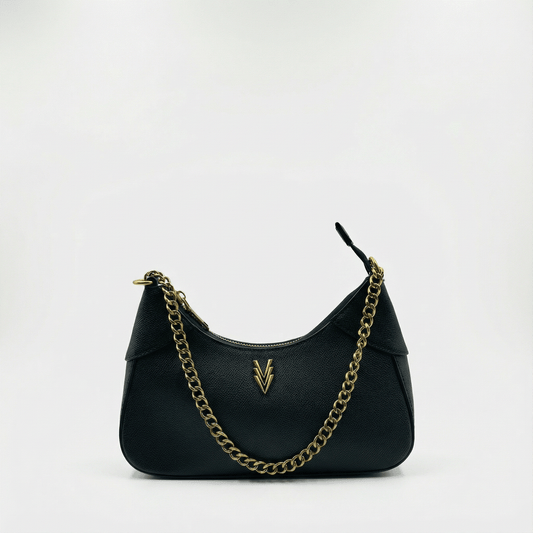Black handbag with gold chain strap on a white background