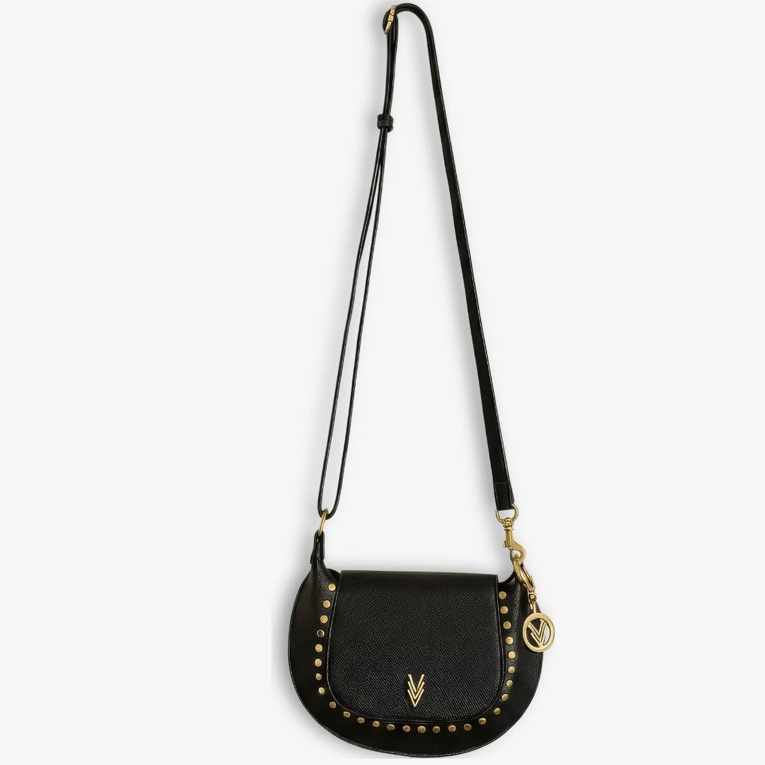 Black crossbody bag with gold accents on a white background