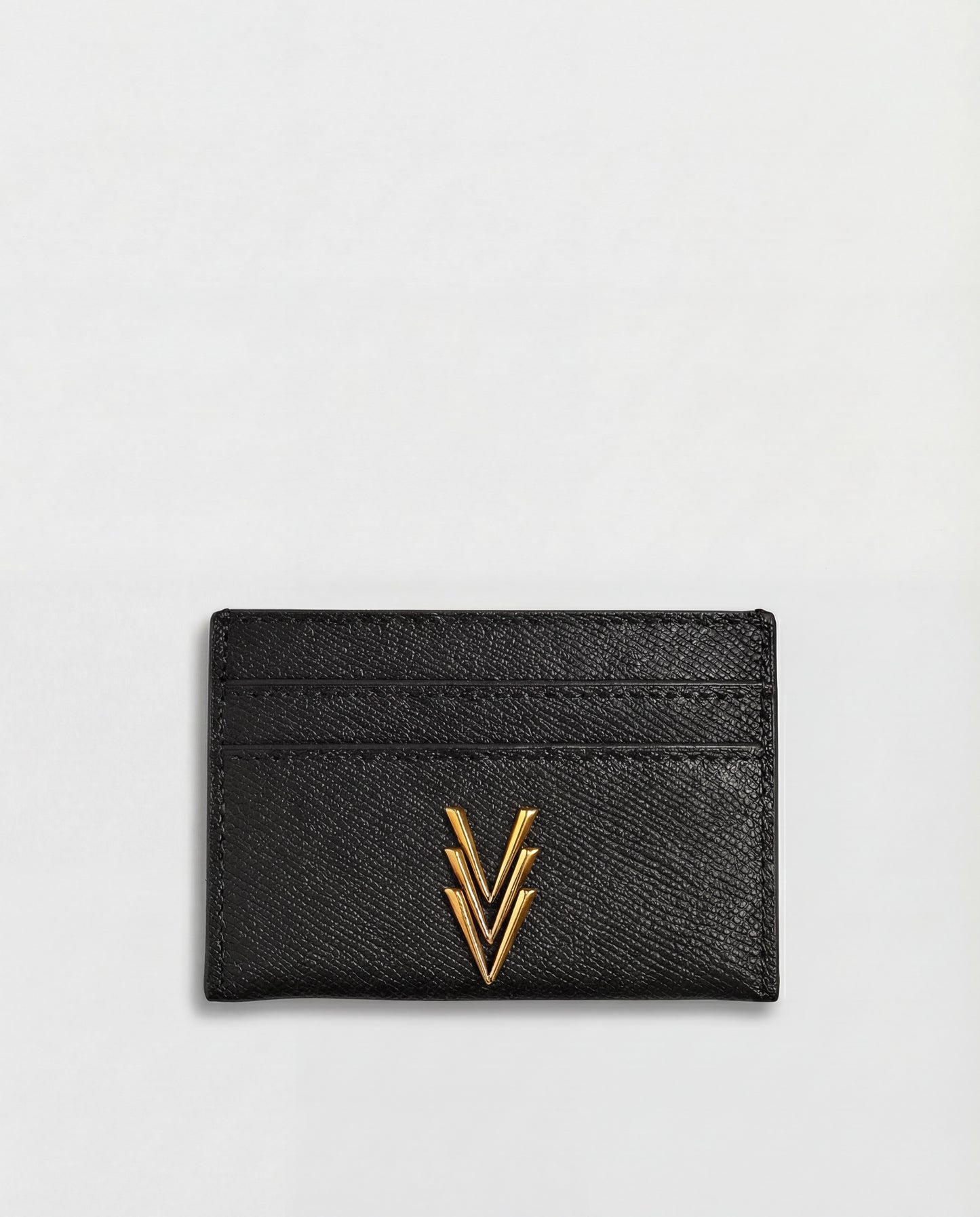 Black cardholder with gold emblem on a light gray background