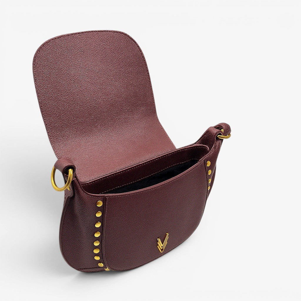 Brown leather handbag with gold accents on a white background