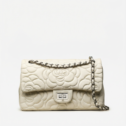 White quilted handbag with a chain strap on a white background
