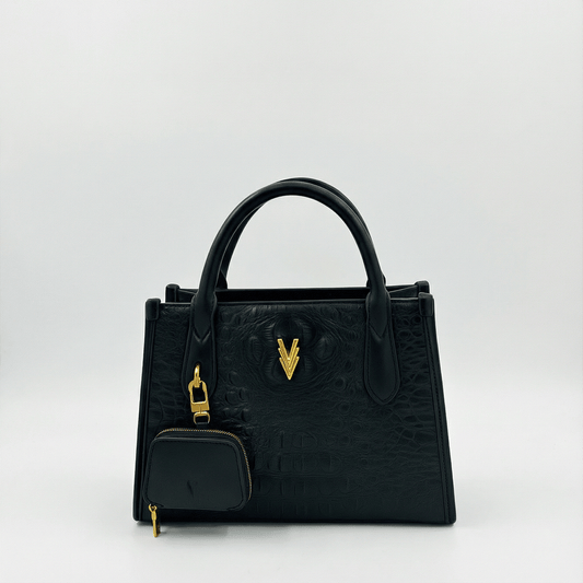 Black handbag with gold accents on a white background