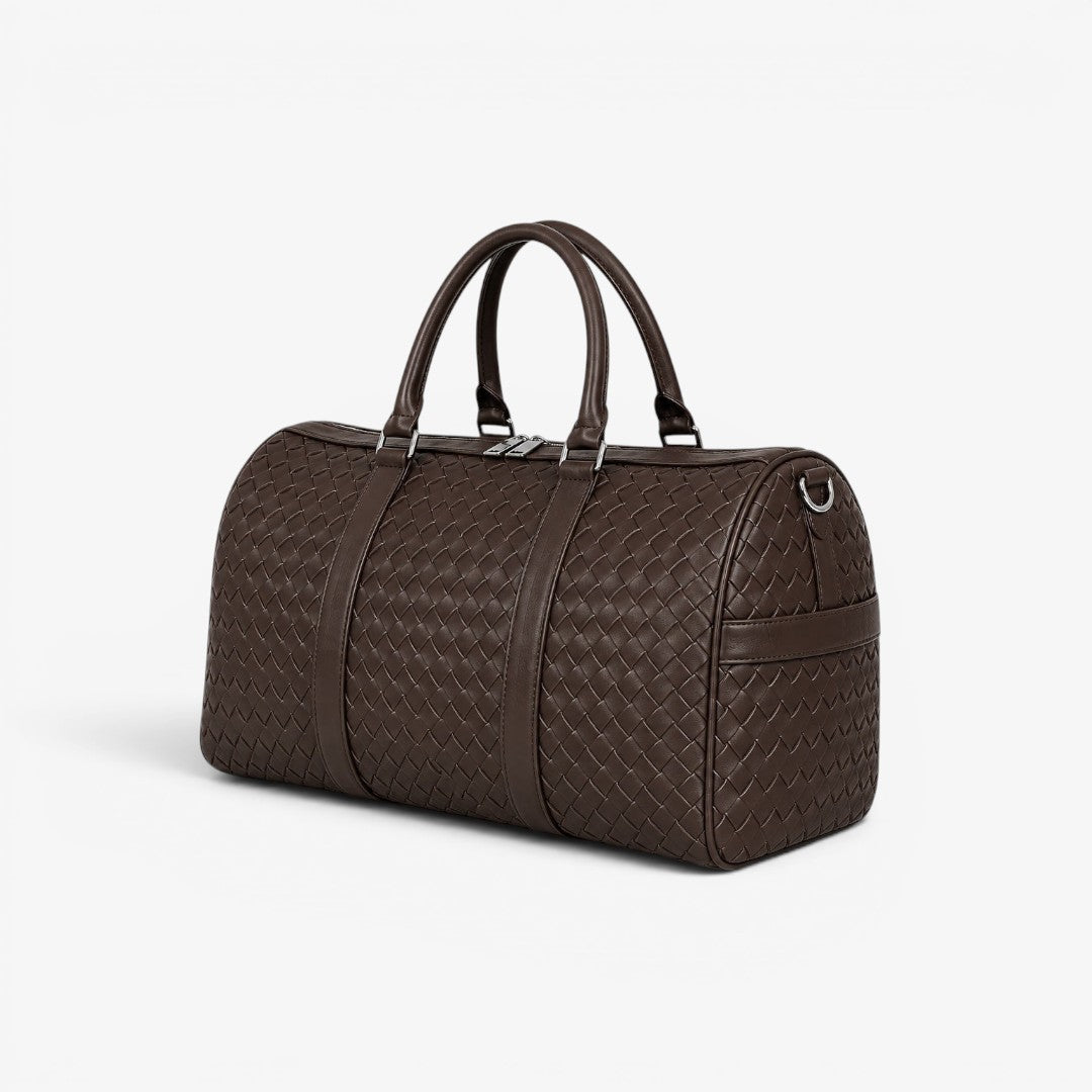 Brown quilted duffel bag on a white background
