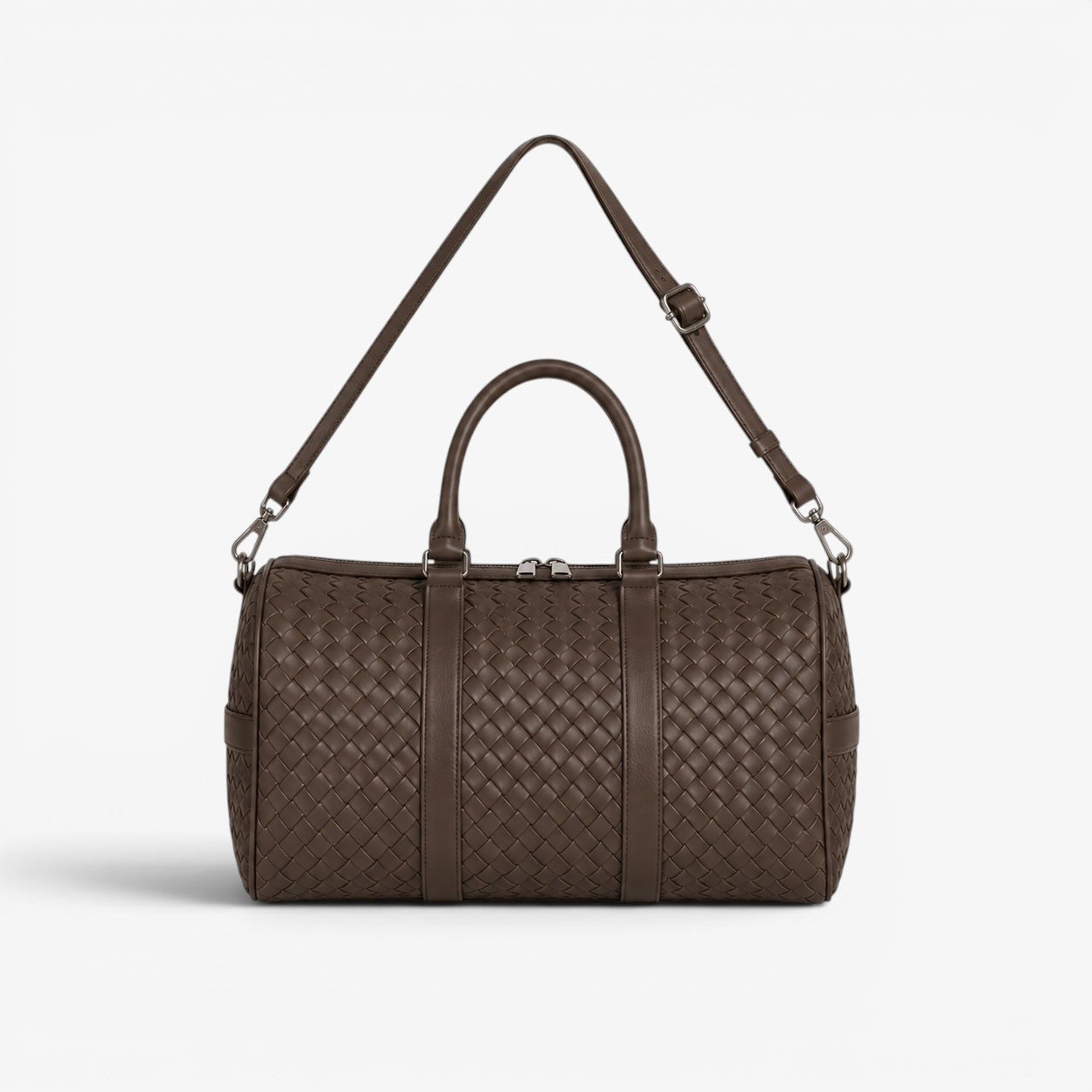 Brown woven leather duffel bag on a white background