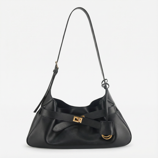 Black handbag with gold accents on a light gray background