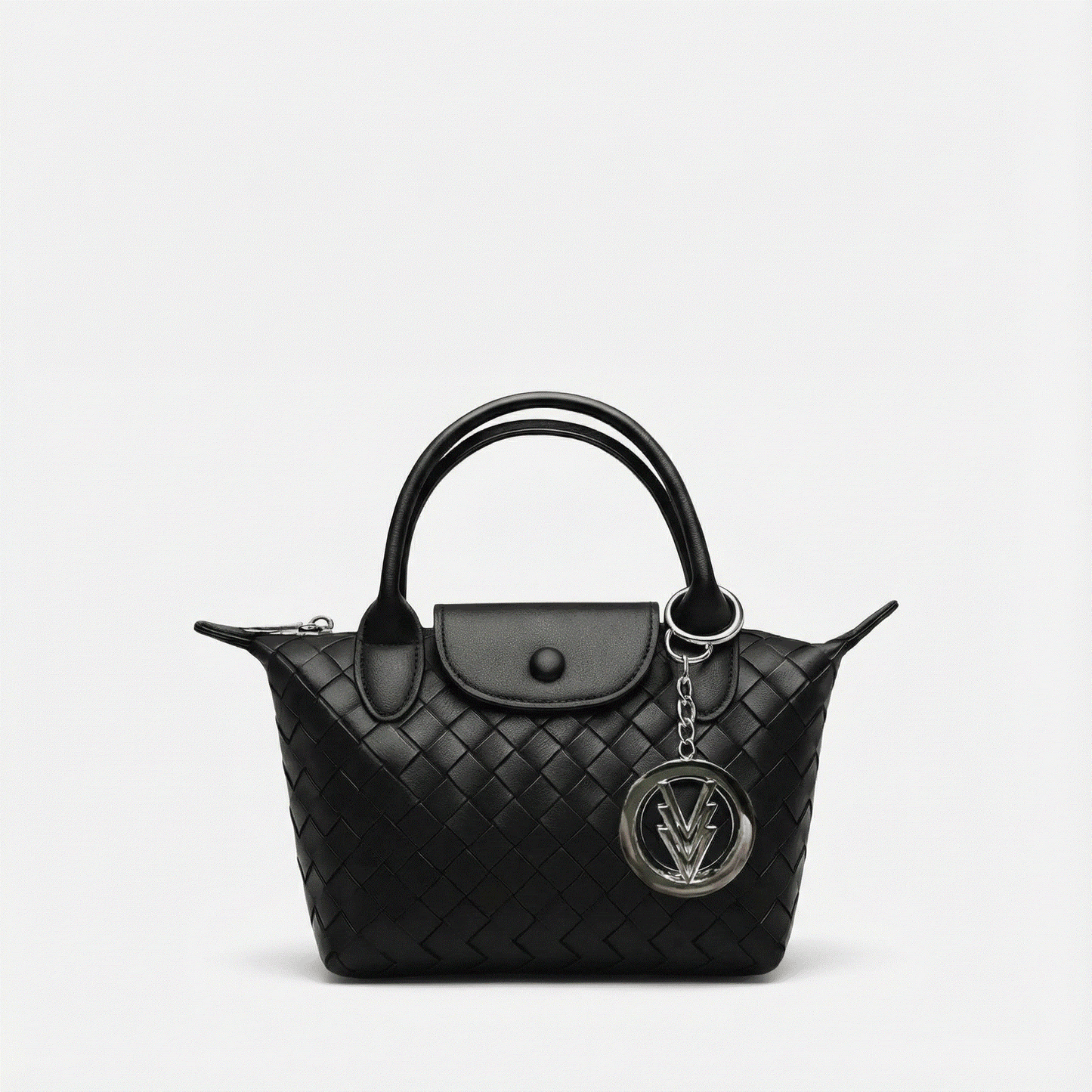 Black quilted handbag with a chain detail on a light gray background