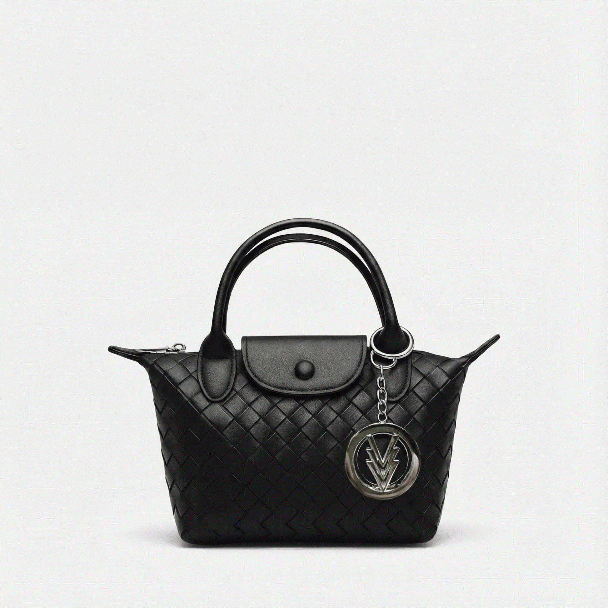 Black quilted handbag with a chain detail on a light gray background
