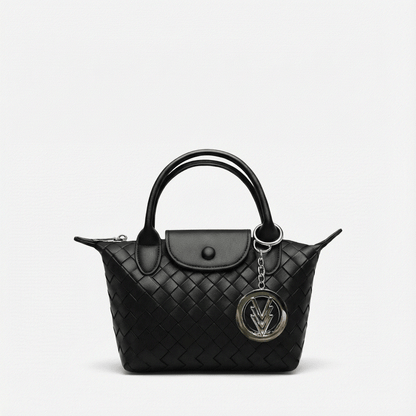 Black quilted handbag with a chain detail on a light gray background