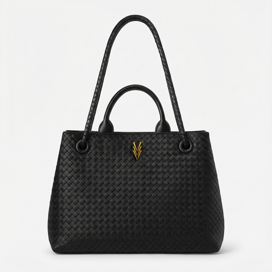Black woven handbag with a gold logo on a light gray background