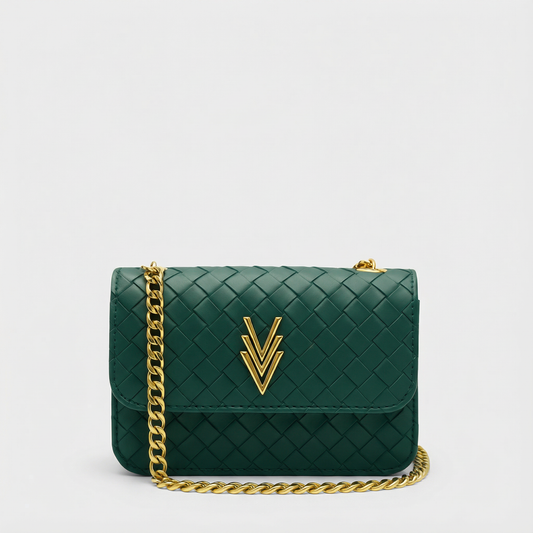 Green handbag with gold chain and logo on a light gray background