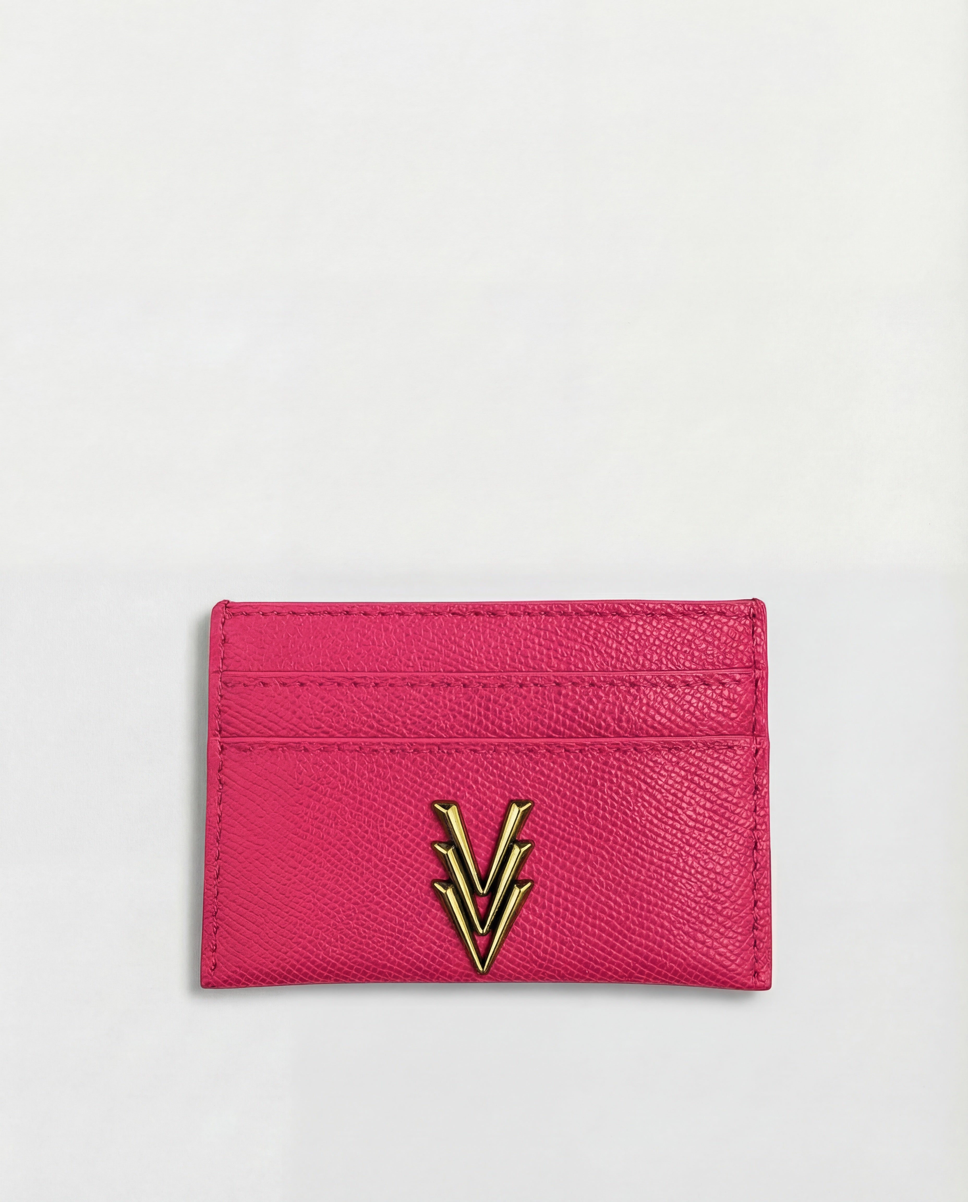 Pink cardholder with a gold emblem on a light gray background