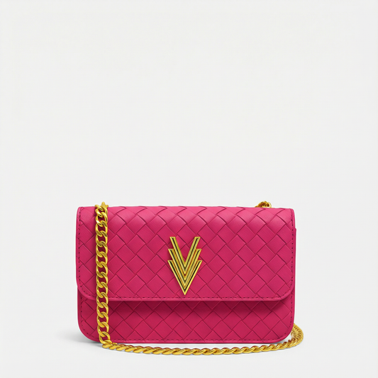 Pink handbag with gold chain and logo on a light gray background