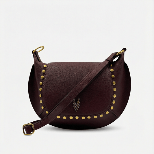 Brown leather handbag with gold studs and a visible brand logo on a light gray background