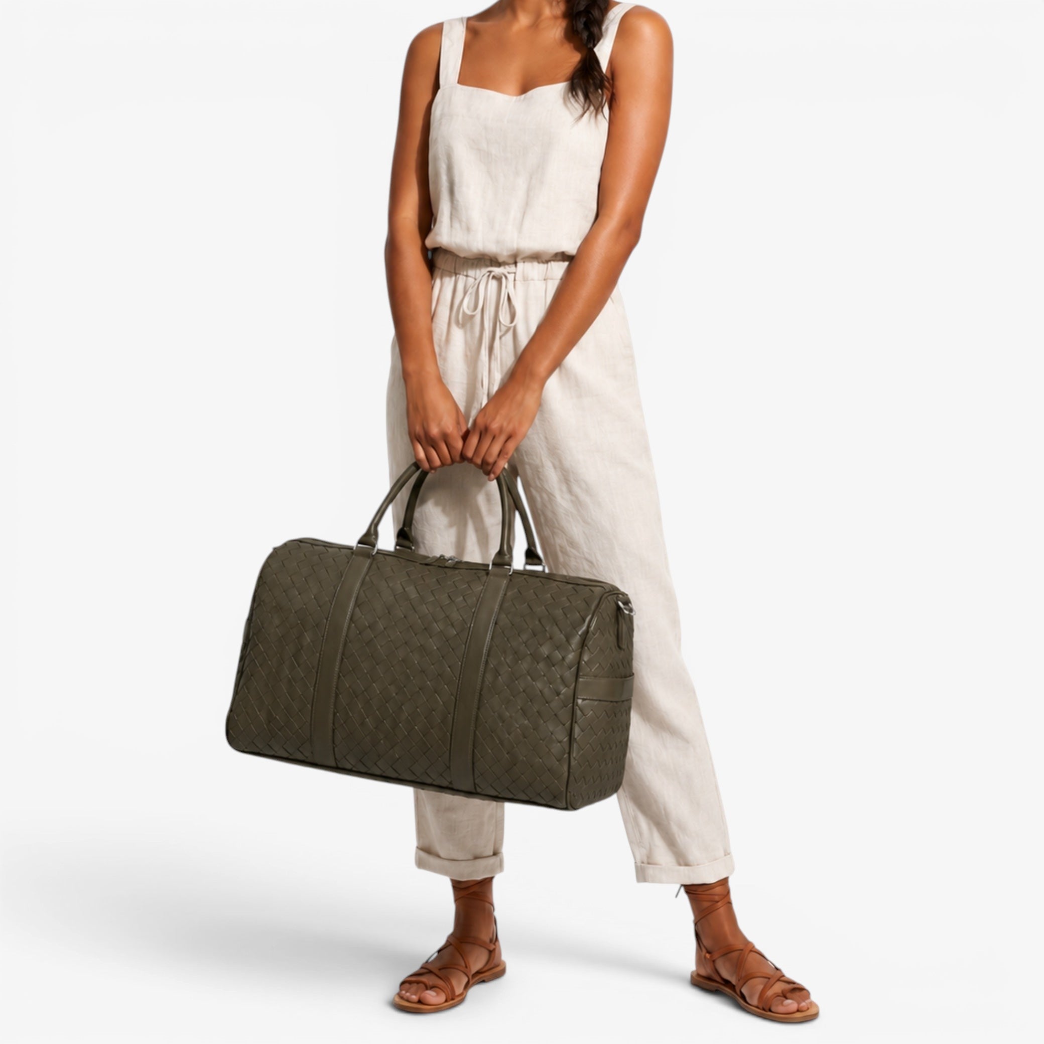 Woman holding a green duffel bag against a white background