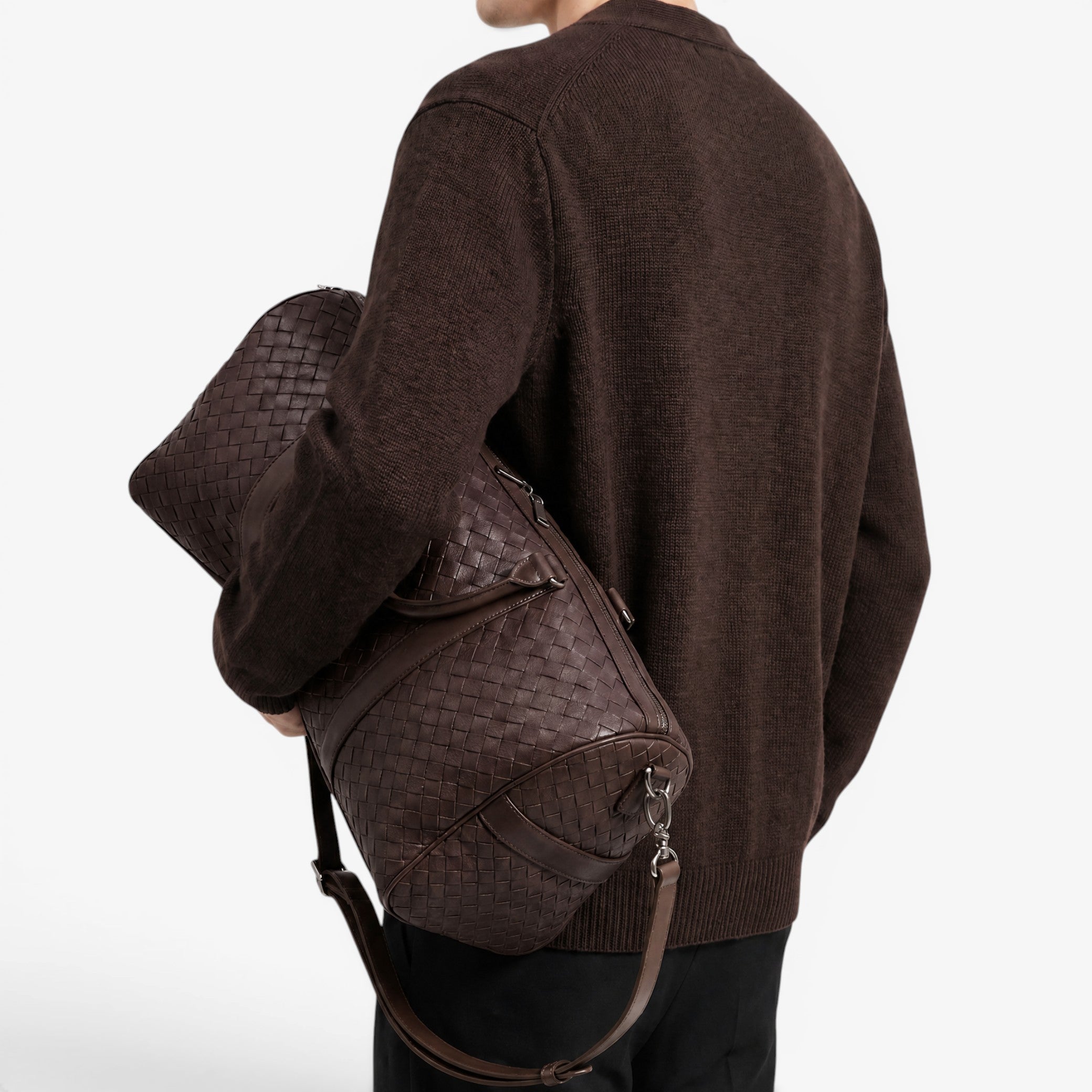 Person wearing a brown textured backpack on a white background