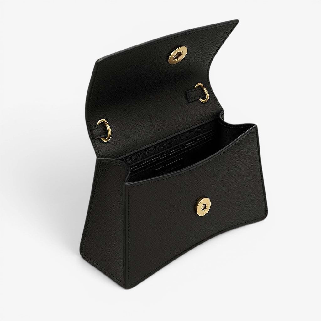 Black handbag with gold hardware on a white background