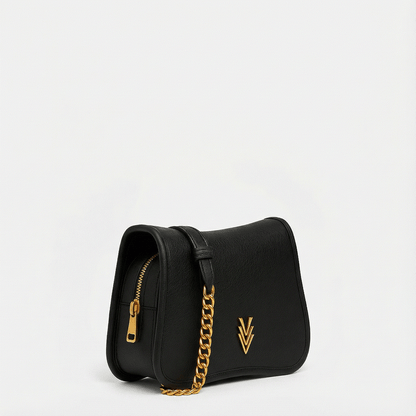 Black handbag with a gold chain and logo on a light gray background