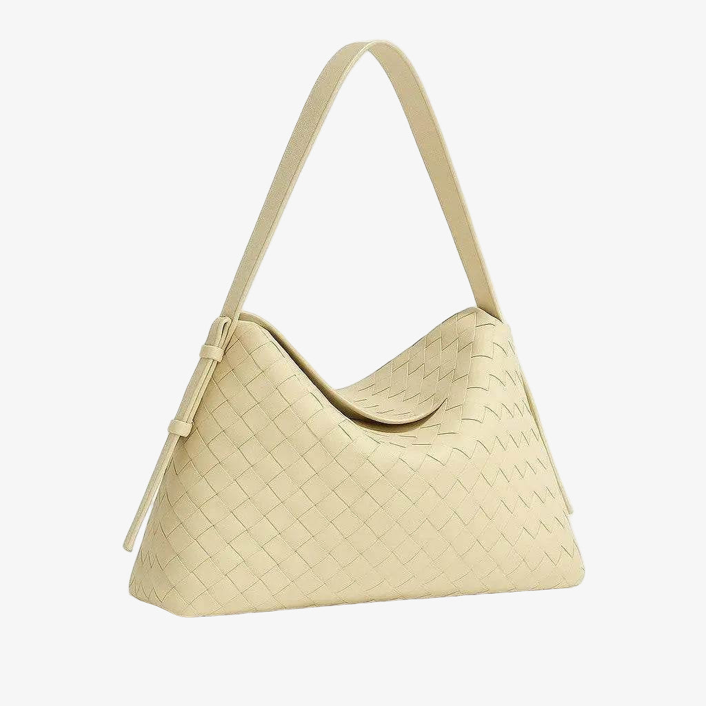 Beige woven handbag on a light gray background