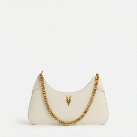 White handbag with gold chain strap on a white background