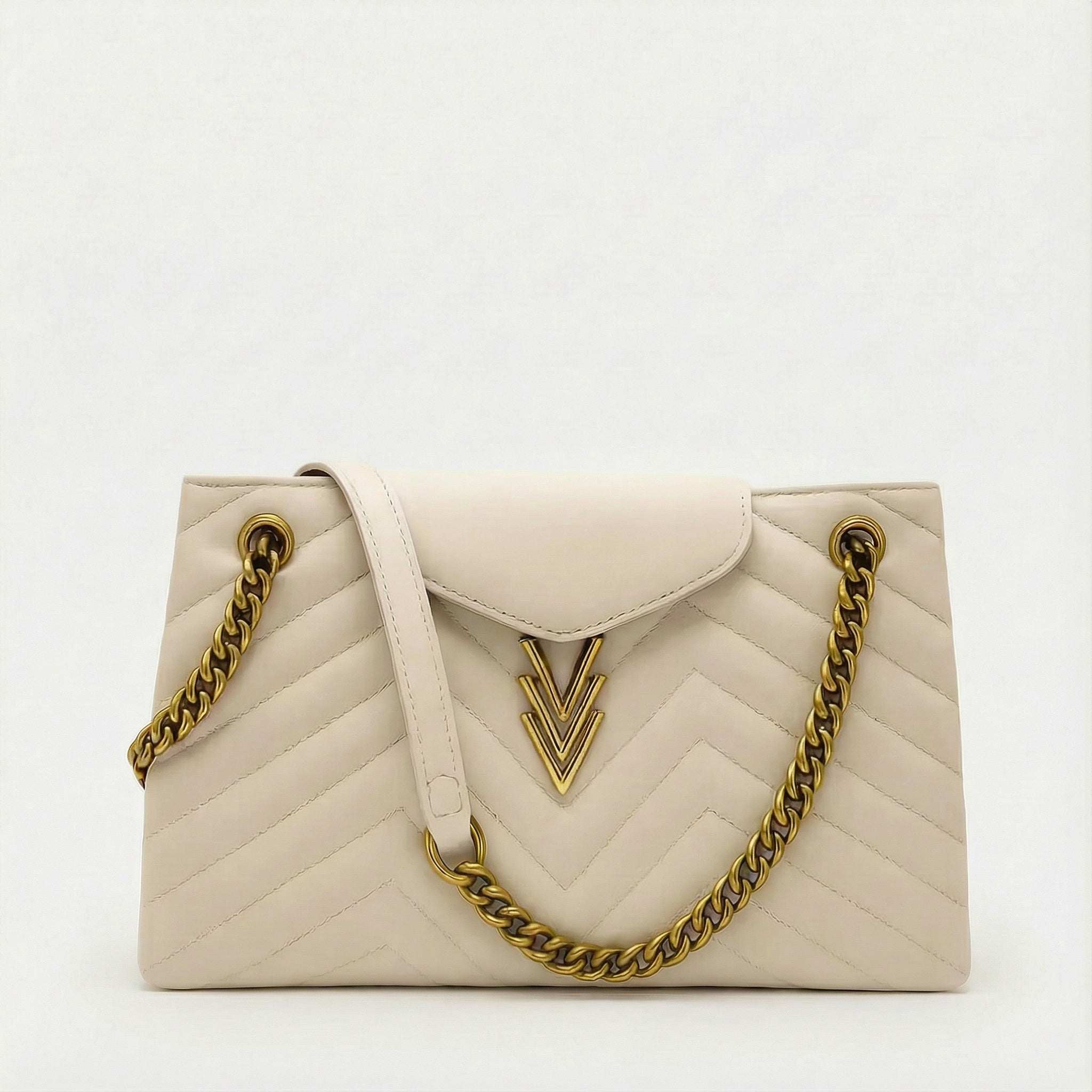White handbag with gold chain strap on a white background