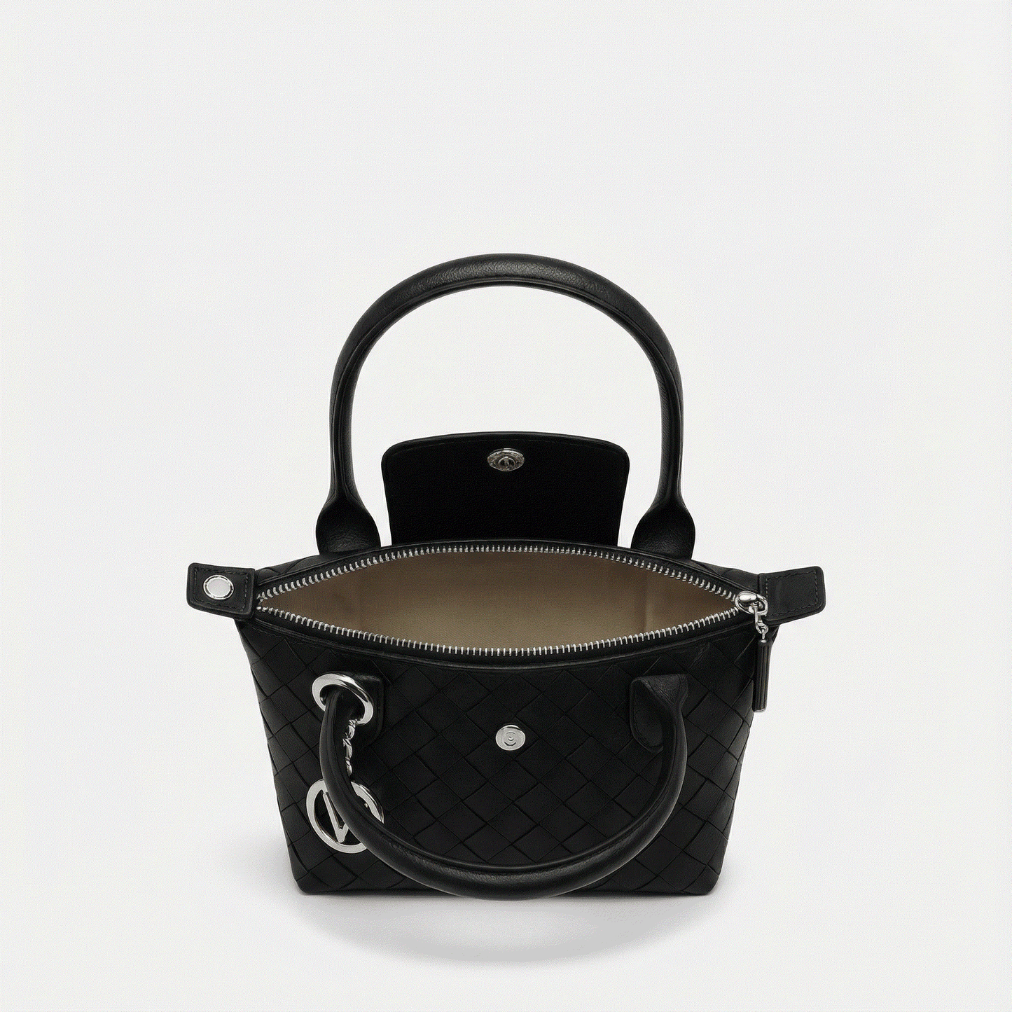 Black quilted handbag with gold hardware on a light gray background